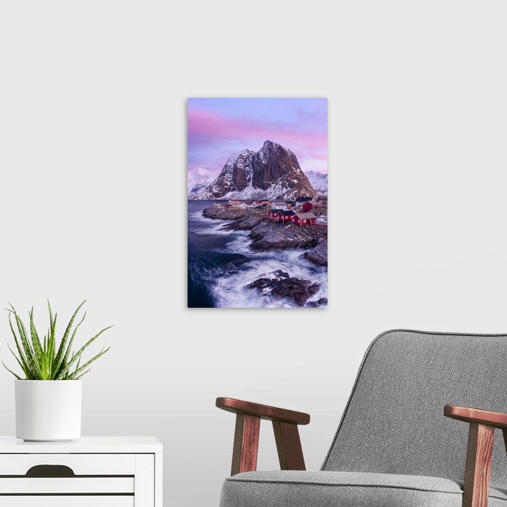A modern room featuring A photograph of a snow covered mountainscape under a pink and purple sky.