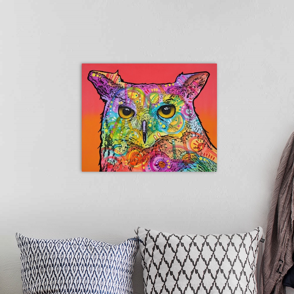 A bohemian room featuring Colorful painting of an owl with abstract designs on a red and orange background.