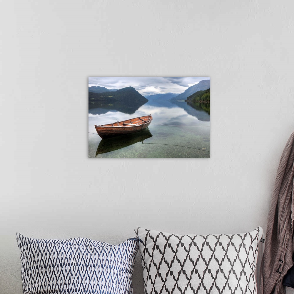 A bohemian room featuring Red rowing boat on a still lake, Norway