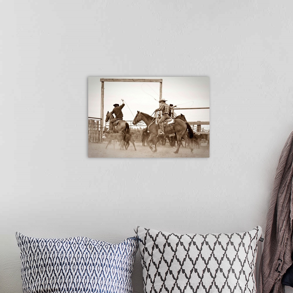 A bohemian room featuring Cowboys on horseback roping steer in corral