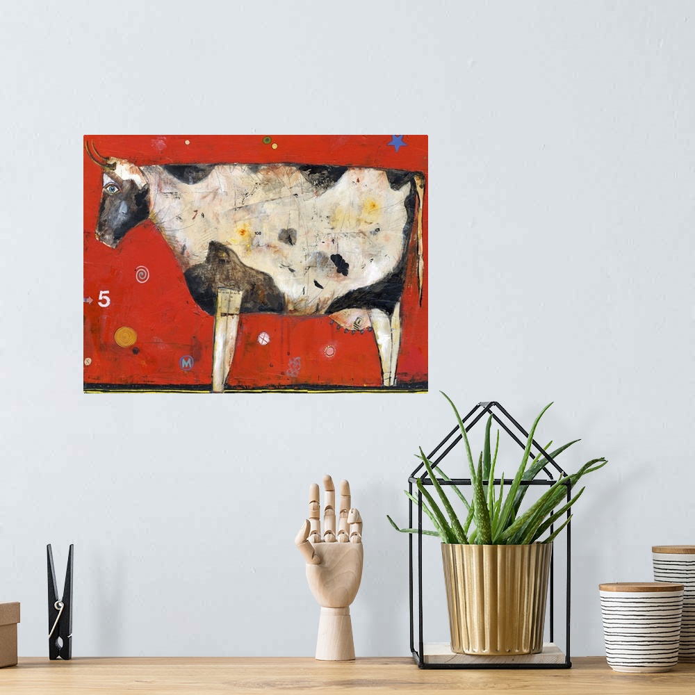 A bohemian room featuring Lighthearted contemporary painting of cow against a red background.