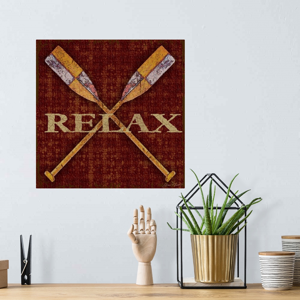 A bohemian room featuring Home decor artwork of crossed rowboat oars against a dark red background with the word Relax in g...