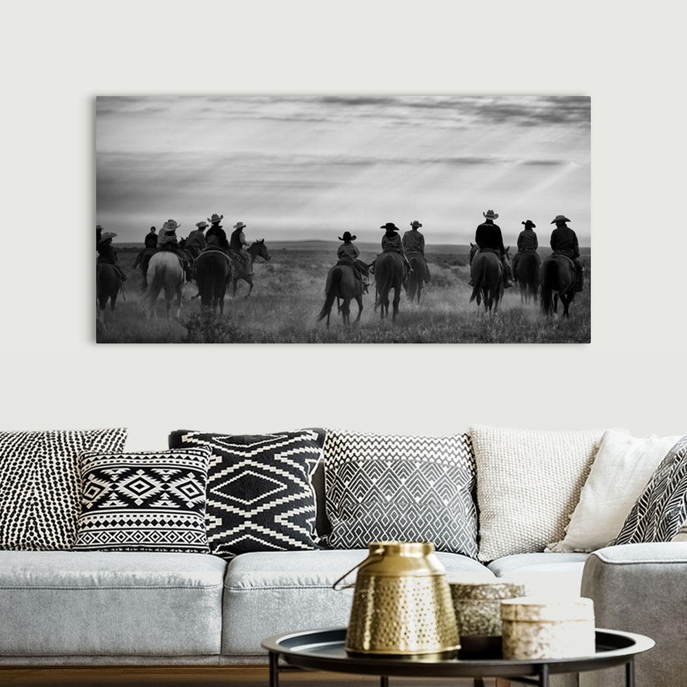A bohemian room featuring group of riders in the western landscape