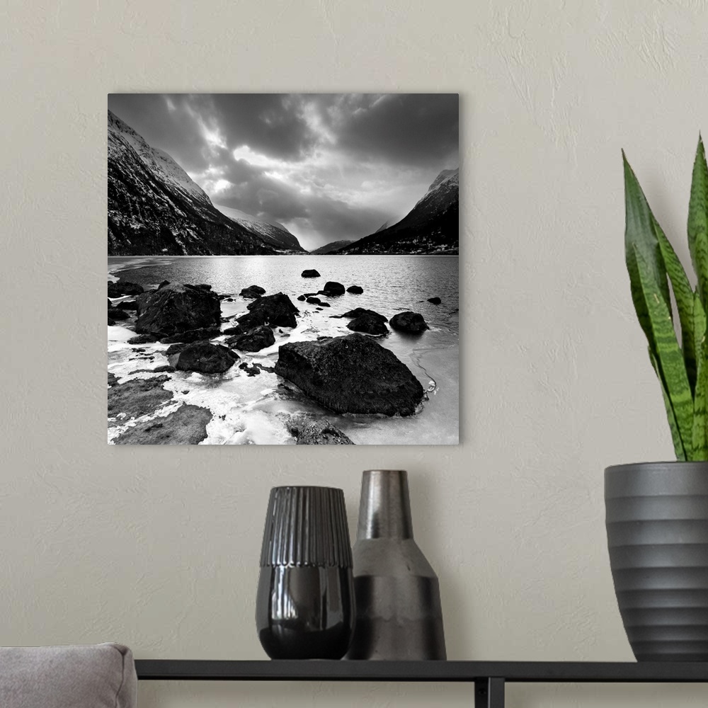 A modern room featuring Rocky shoreline with mountains in the distance