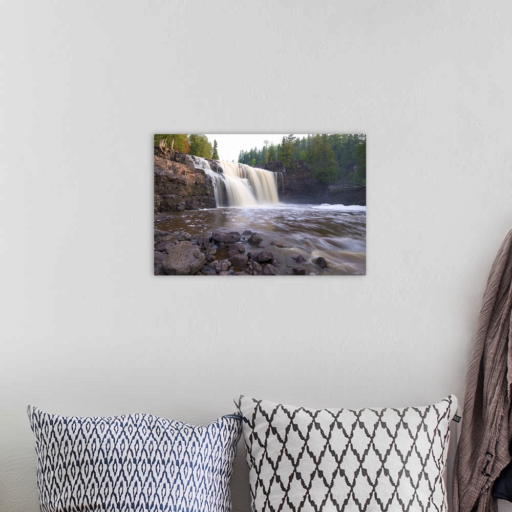 A bohemian room featuring Photograph of a waterfall caught in motion blur surrounded by forest.