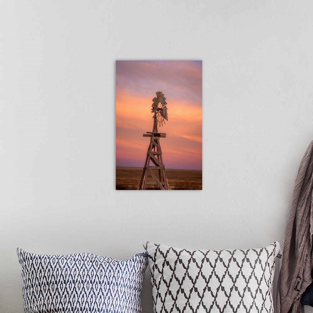 A bohemian room featuring Photograph of a wooden windmill in the middle of a field at sunset.