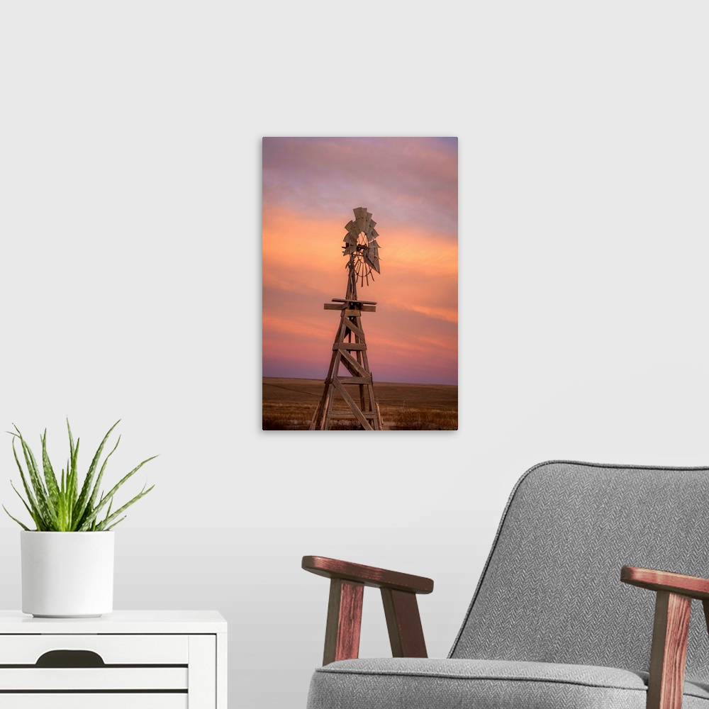 A modern room featuring Photograph of a wooden windmill in the middle of a field at sunset.