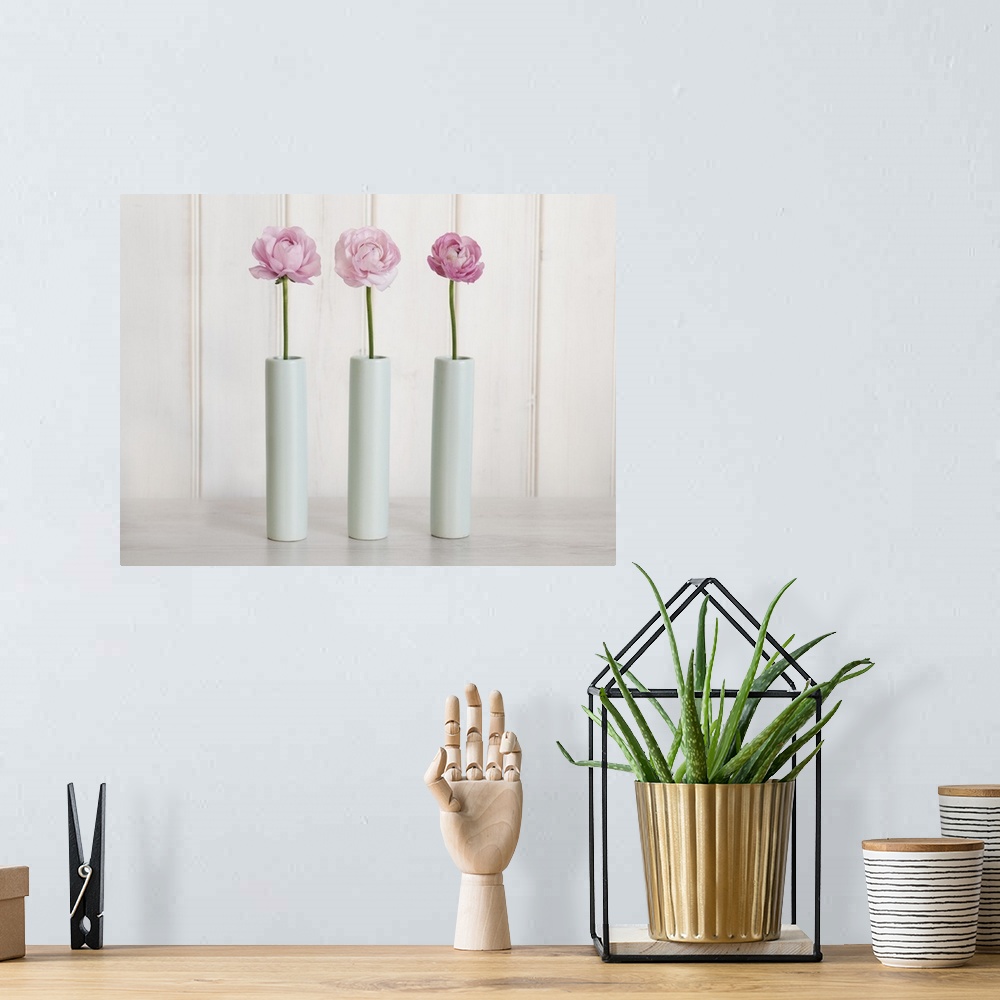 A bohemian room featuring Row Of 3 Pink Flowers In Blue Vases