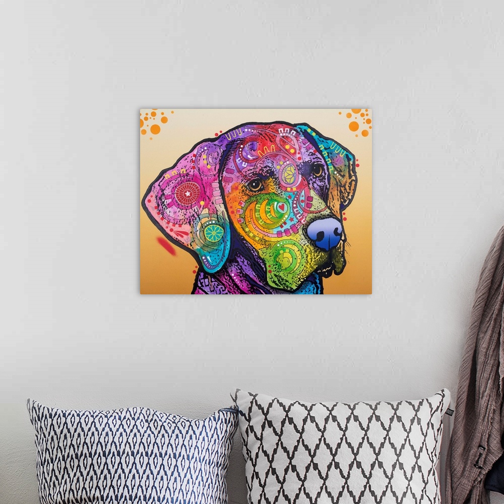 A bohemian room featuring Pop art style painting of a Labrador with different colors and abstract designs on an orange back...
