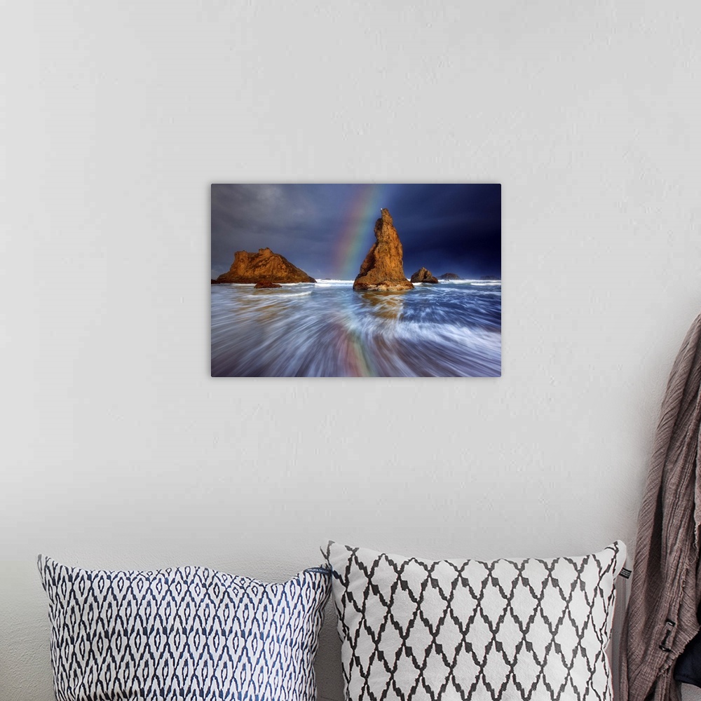 A bohemian room featuring A rainbow over sea stacks in the ocean.