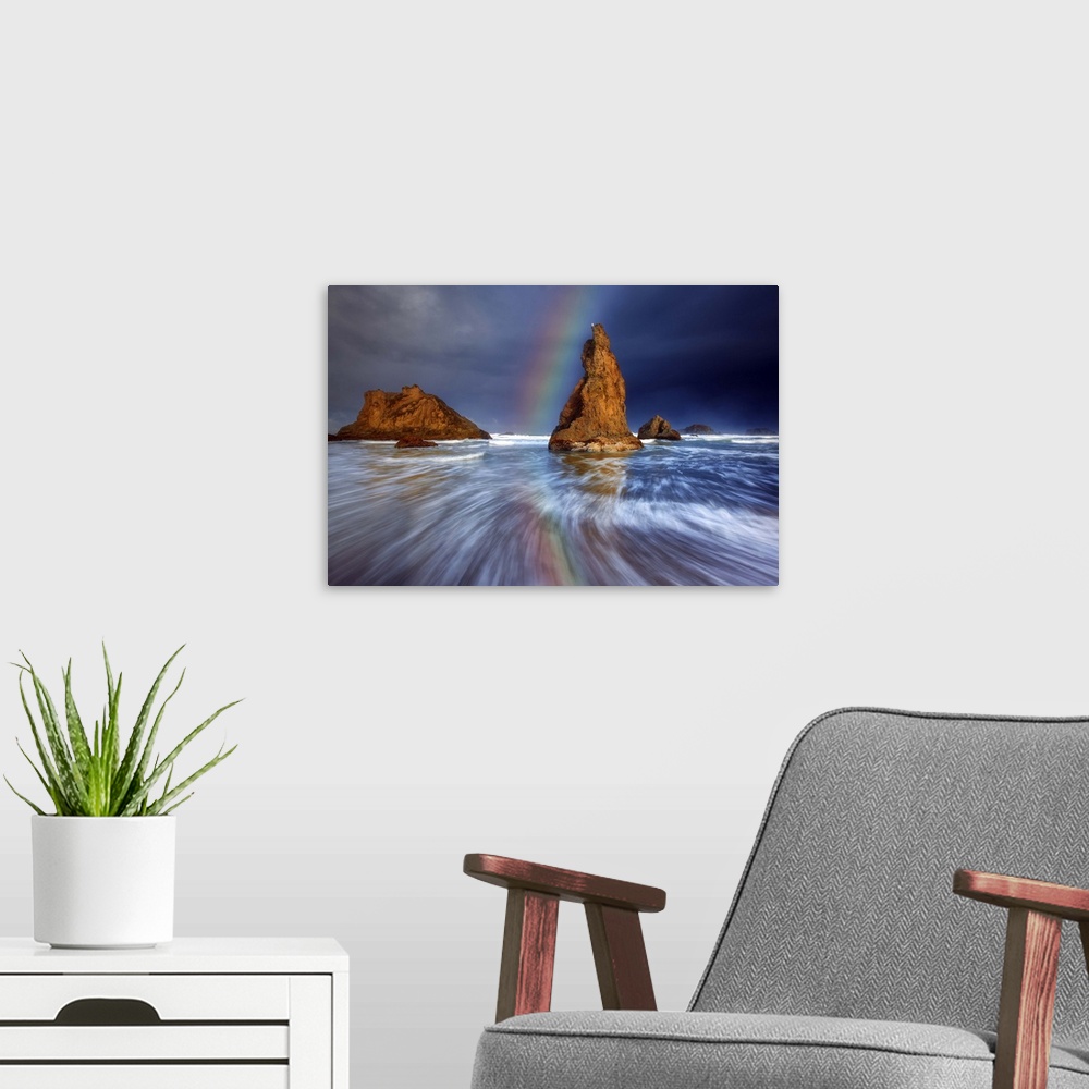 A modern room featuring A rainbow over sea stacks in the ocean.