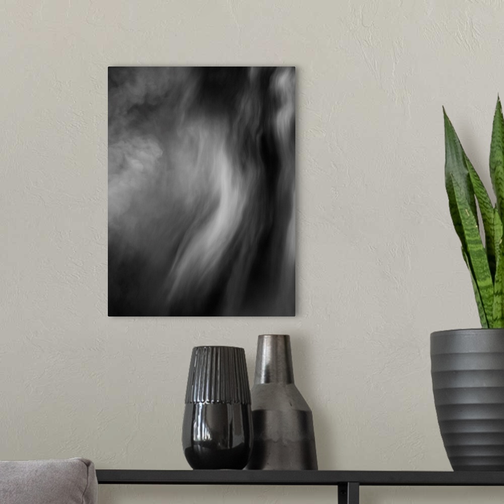 A modern room featuring Black and white smokey abstract photograph.
