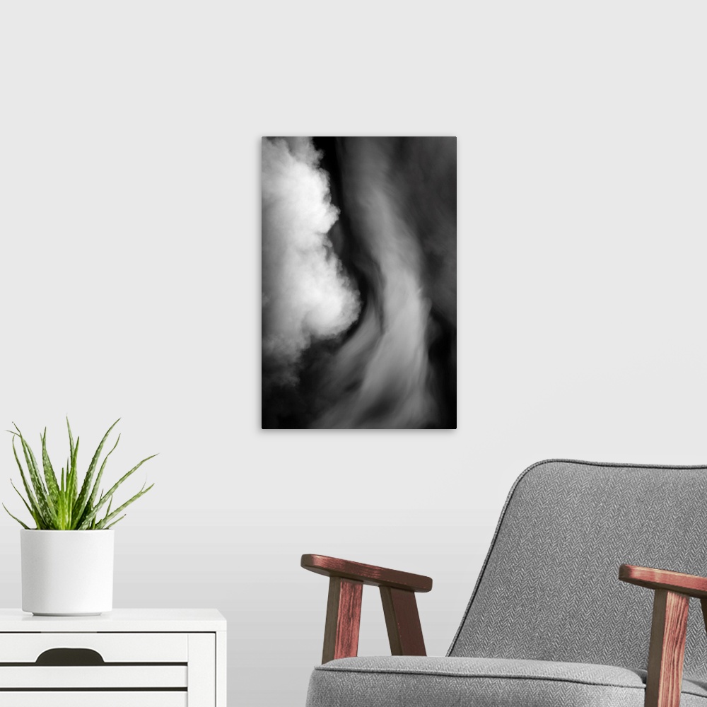 A modern room featuring Black and white smokey abstract photograph.