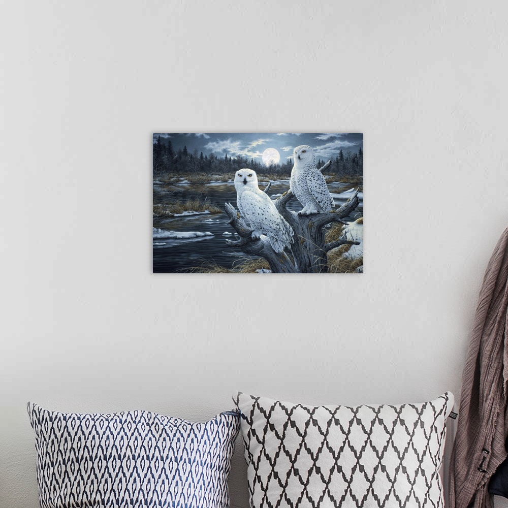 A bohemian room featuring a pair of white owls perched in the top of a dead tree with the moon rising in the background