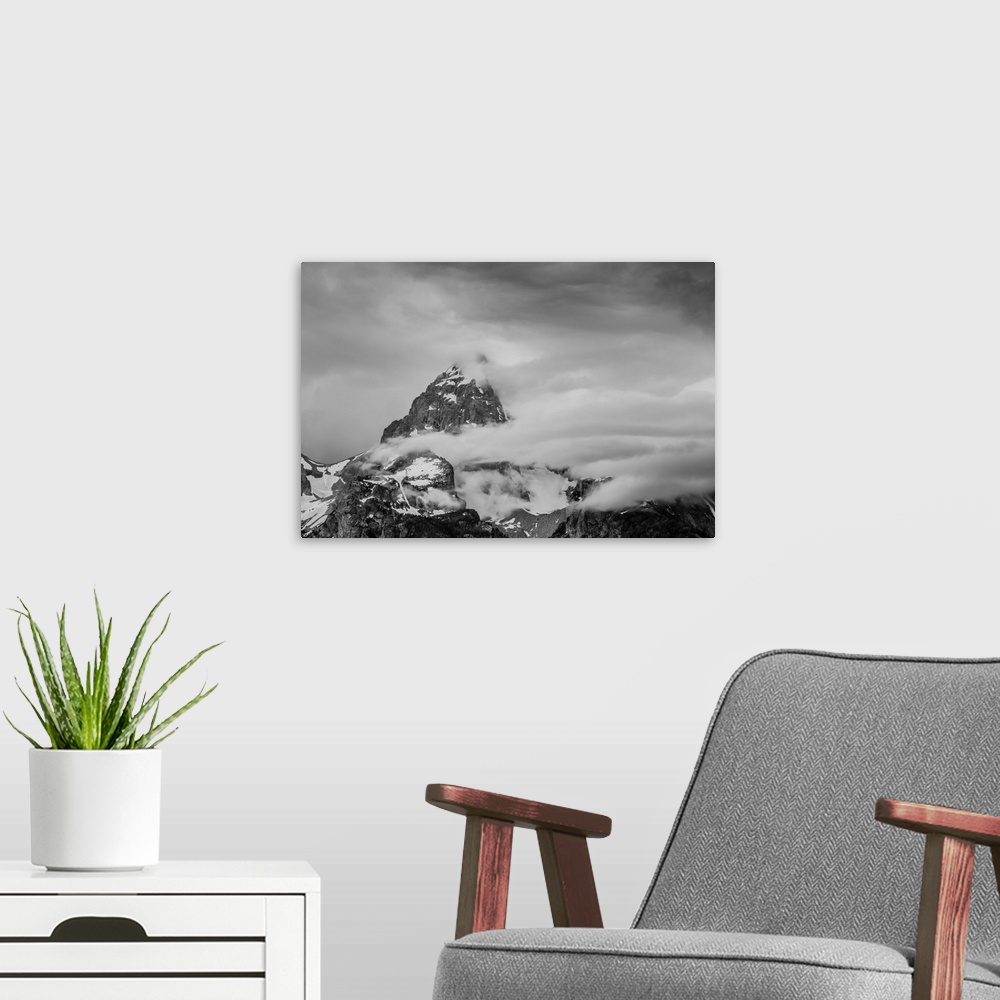 A modern room featuring Black and white photograph of a cloudy mountain peak.
