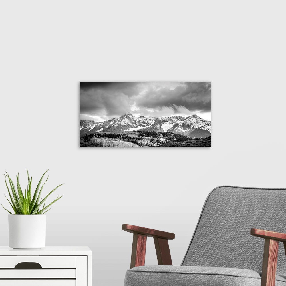 A modern room featuring Black and white landscape photograph of snowy mountains under a cloudy sky.