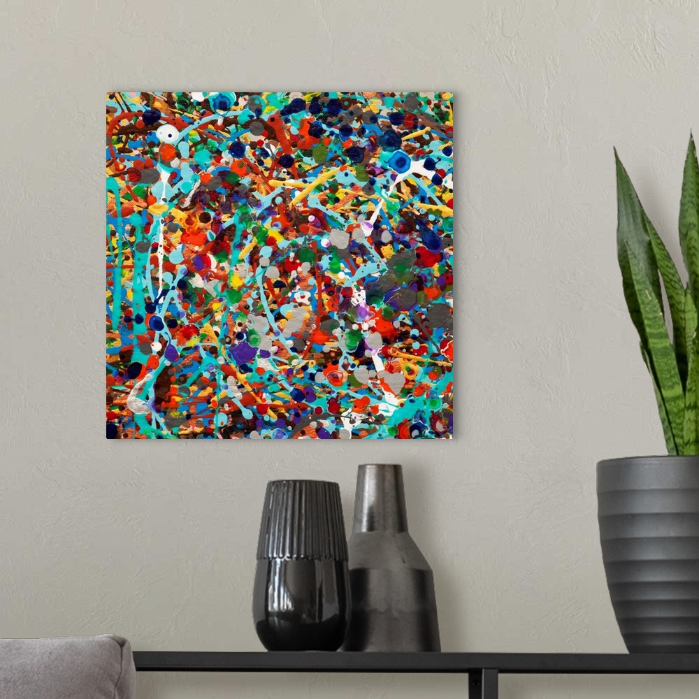 A modern room featuring Contemporary abstract painting made of multicolored paint splatters and swirls.