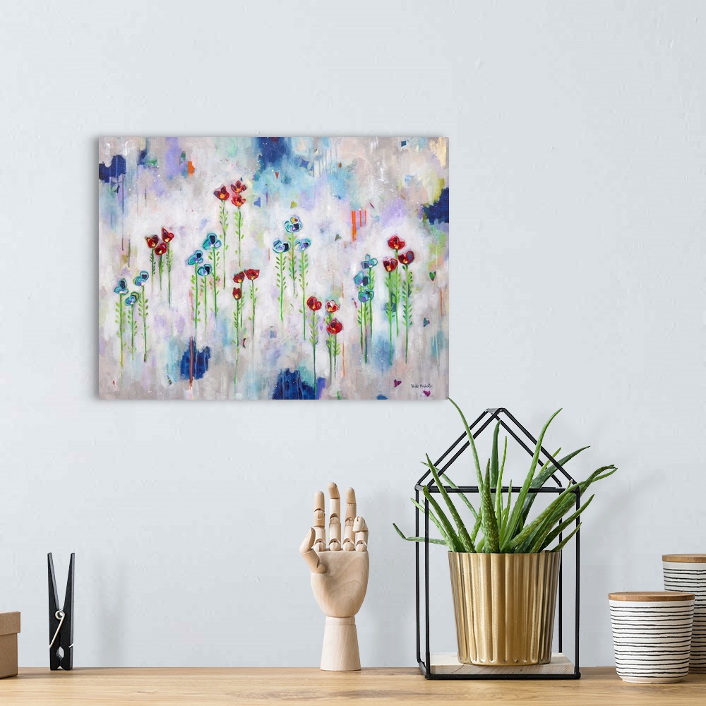 A bohemian room featuring Vibrant abstract painting with blue and red flowers that appear to be floating in sets of three w...