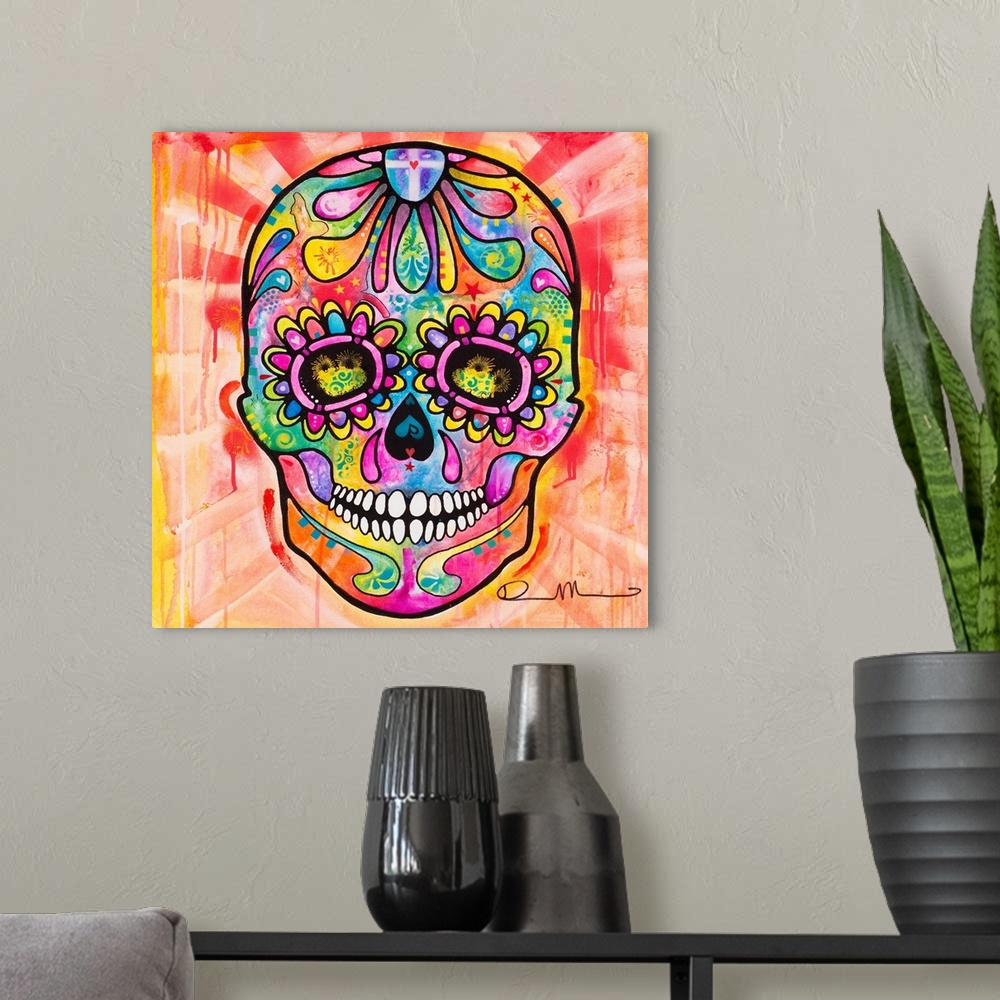 A modern room featuring Bright painting of a skull for Dia de los Muertos with paint dripping in the background.