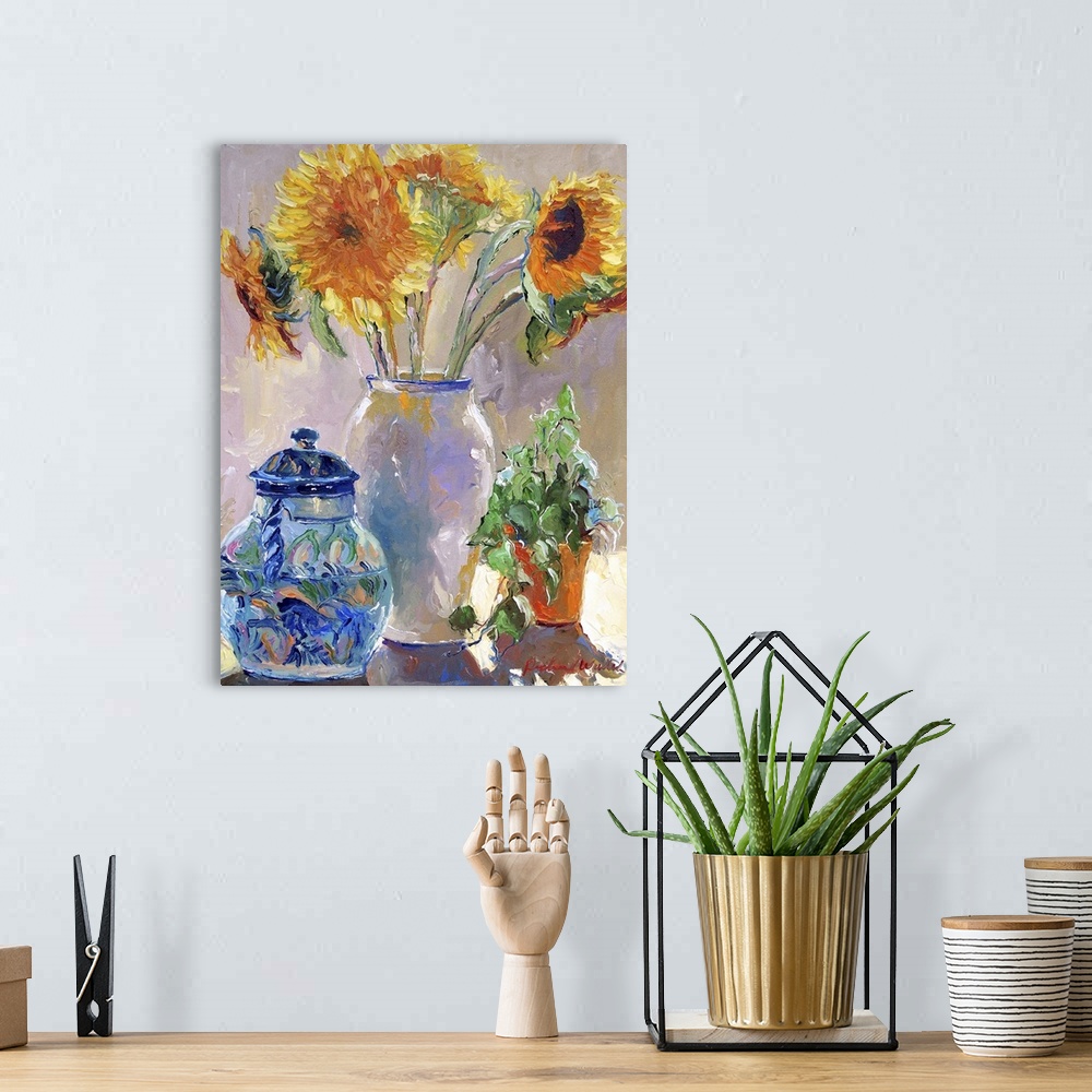 A bohemian room featuring Sunflowers in a white vase.
