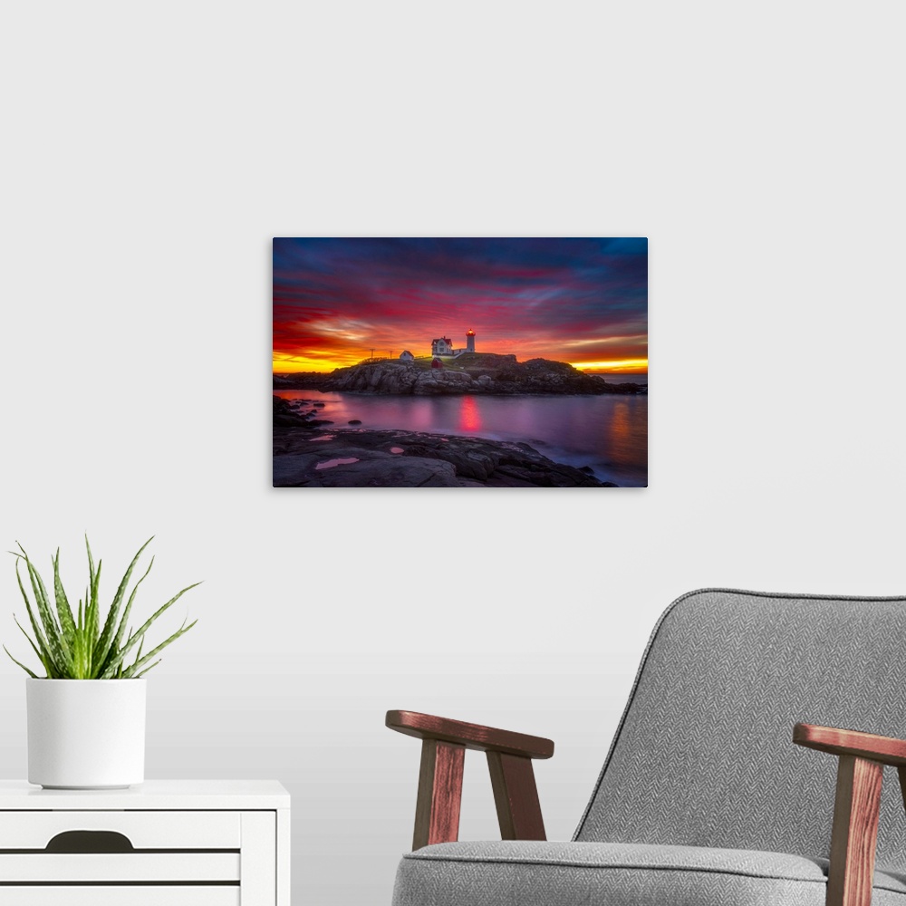 A modern room featuring A vibrant sunset over Cape Neddick Lighthouse in York, Maine.
