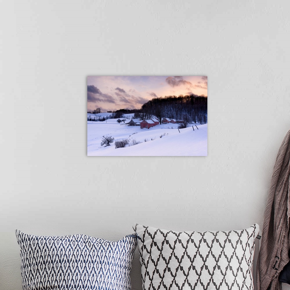A bohemian room featuring Landscape photograph of a snowy Winter farm with red wooden buildings and a pretty sunset.