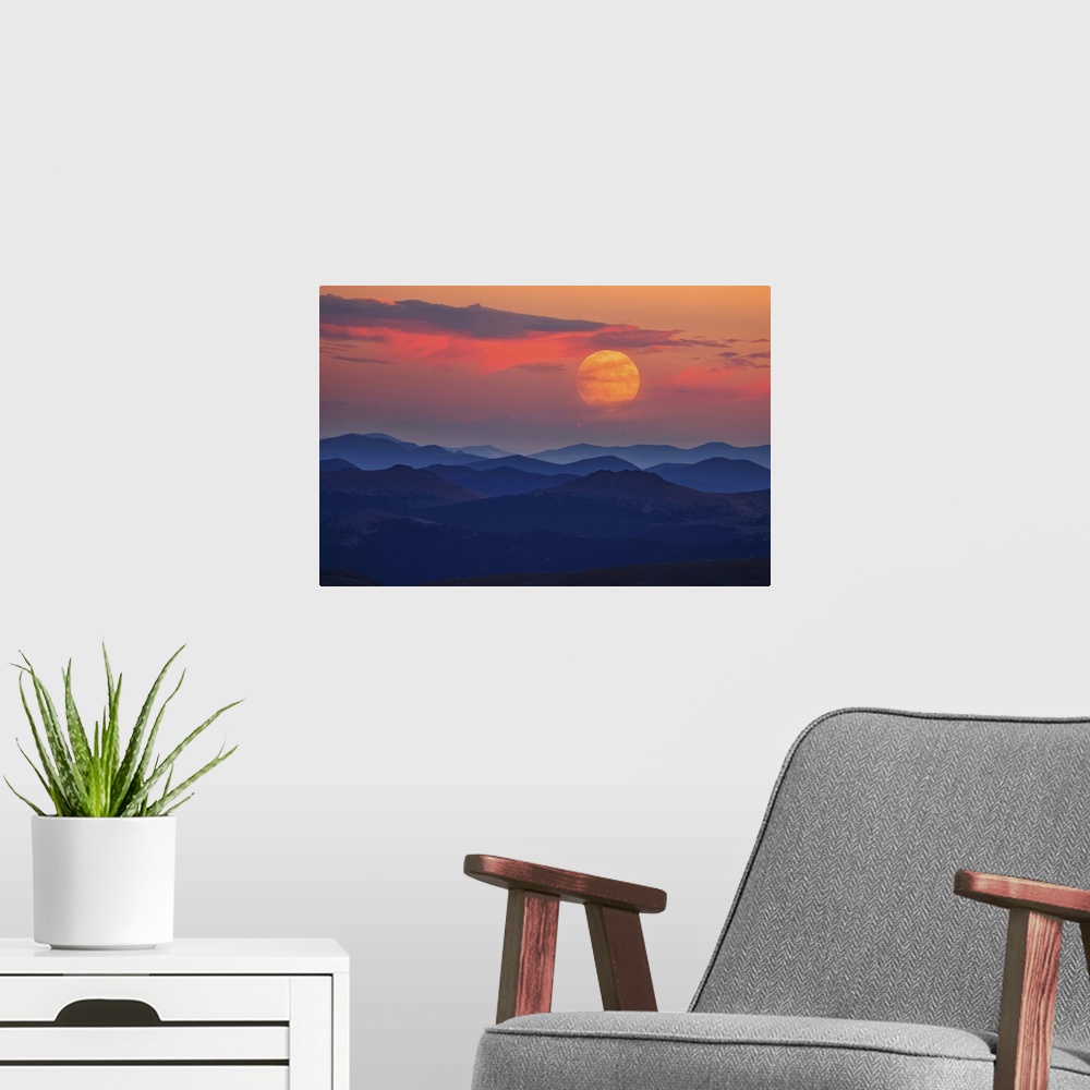 A modern room featuring A glowing moon at dawn over misty mountains.