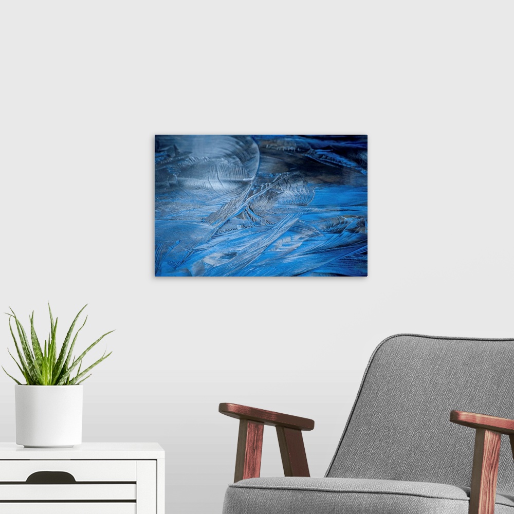 A modern room featuring Close-up abstract photograph of the texture from frozen water in shades of blue.