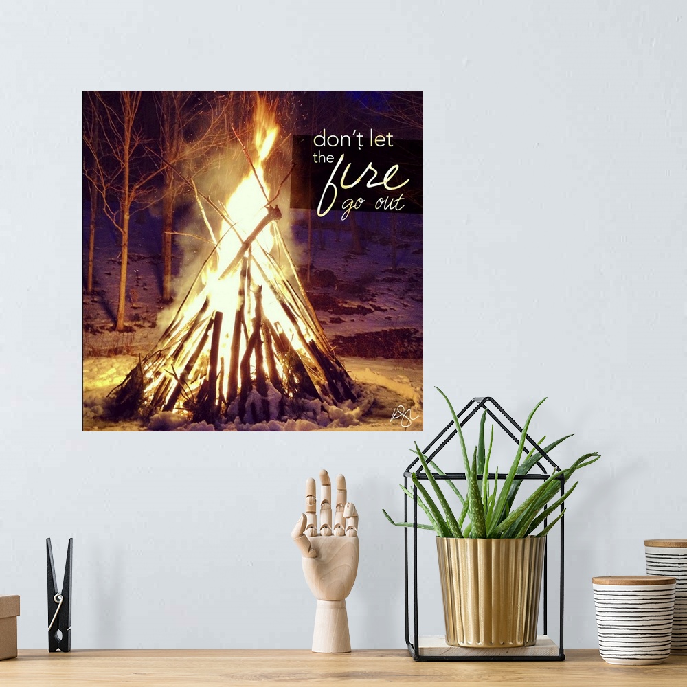 A bohemian room featuring Motivational text against background photograph of a giant campfire.