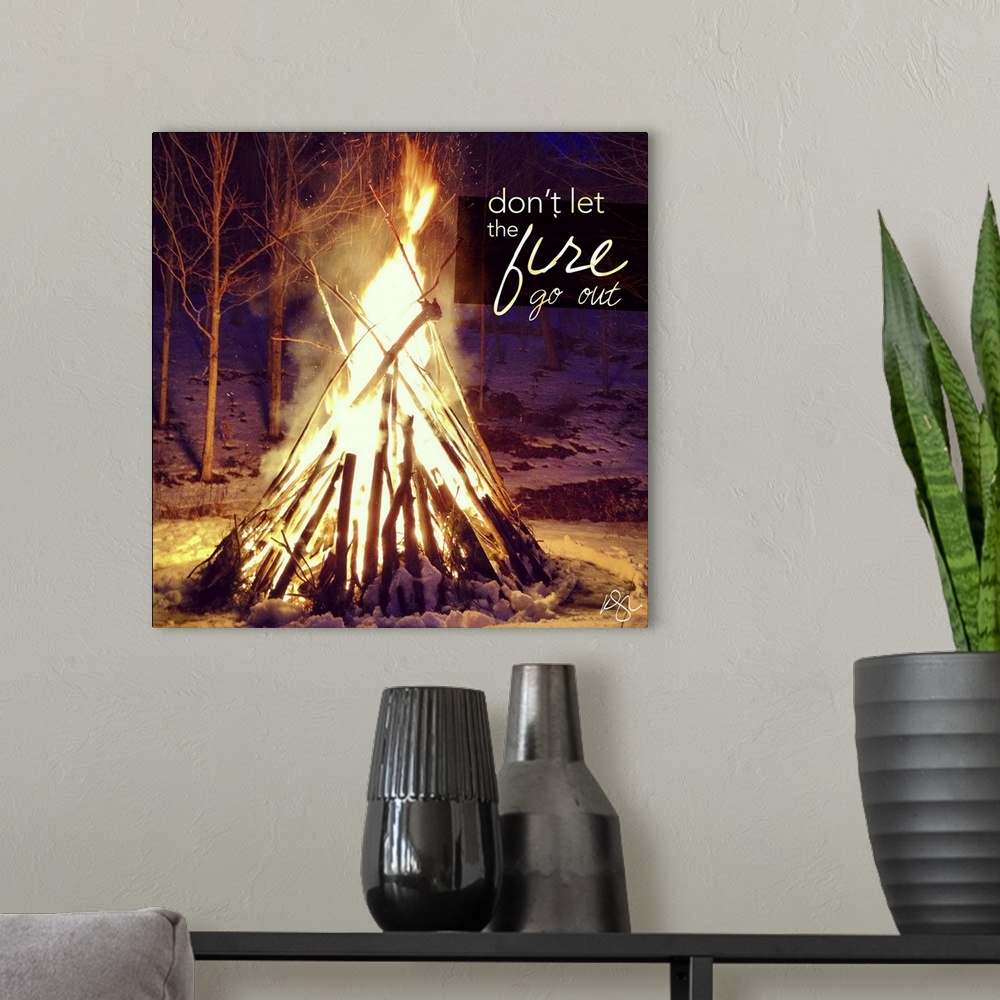 A modern room featuring Motivational text against background photograph of a giant campfire.