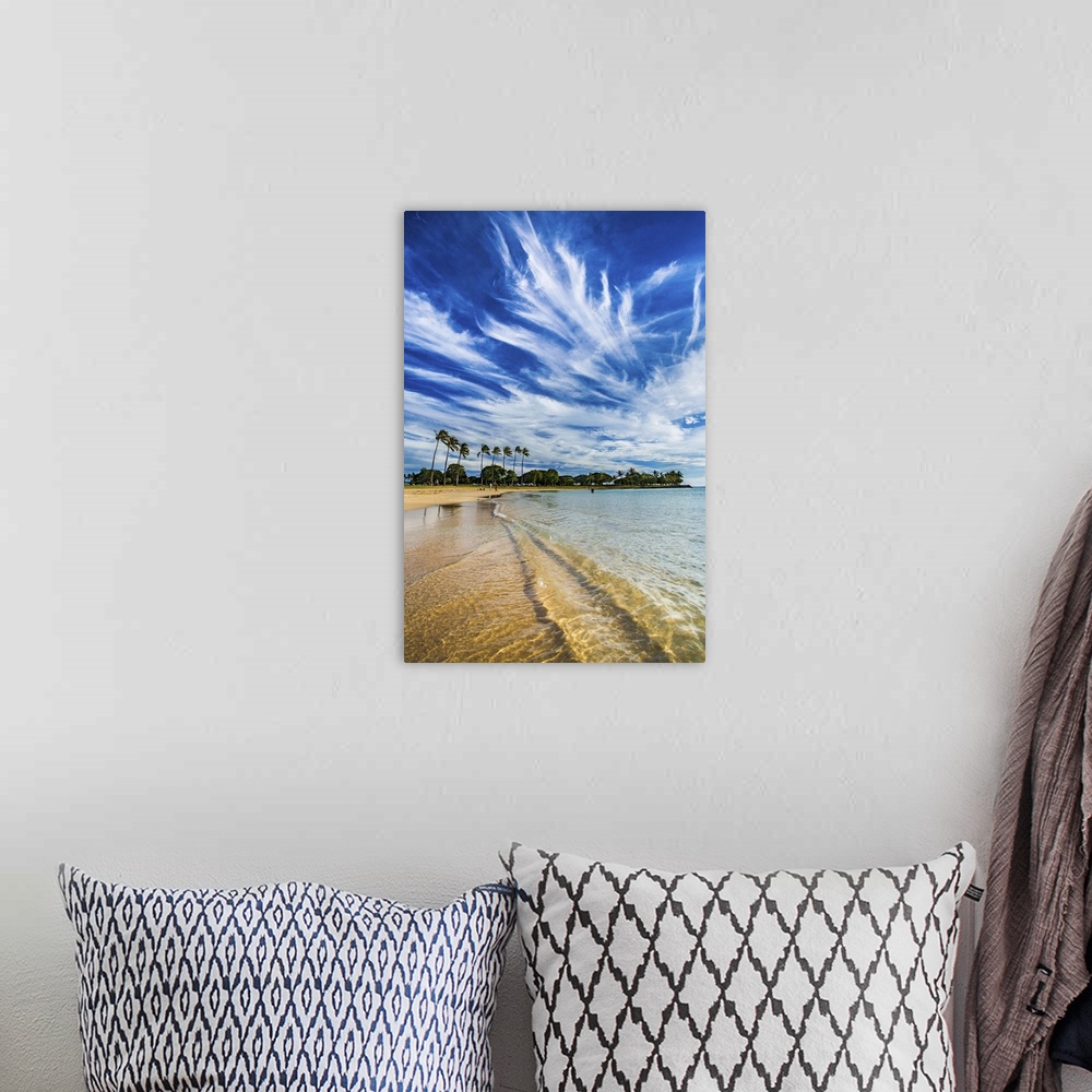 A bohemian room featuring A photograph of long wispy clouds over a tropical Hawaiian beach.