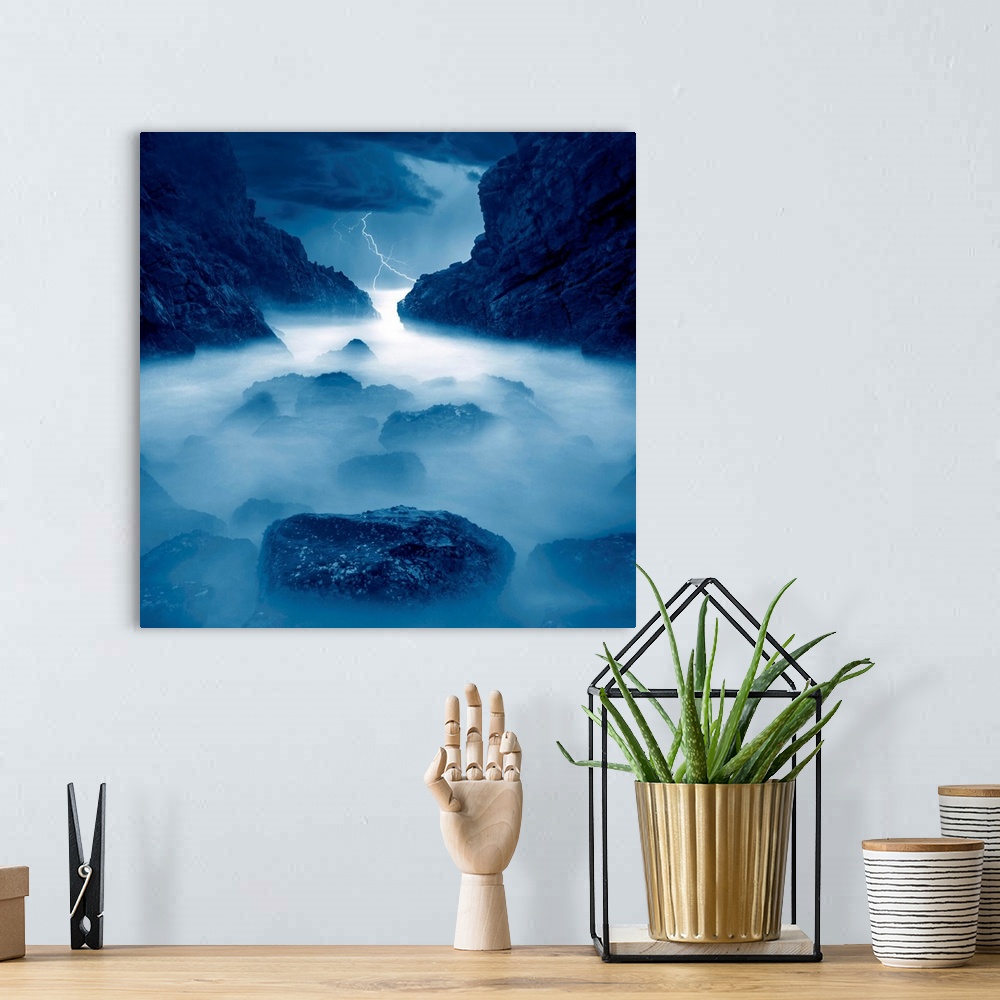 A bohemian room featuring Lightning, rocks, mist, ocean, blue storm