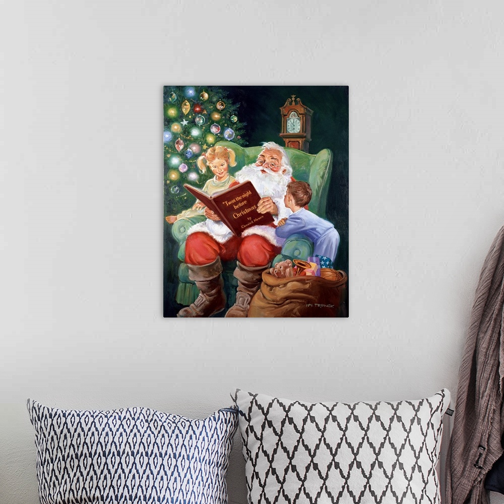 A bohemian room featuring Santa reading Twas The Night Before Christmas with a young boy and girl on either side, next to a...