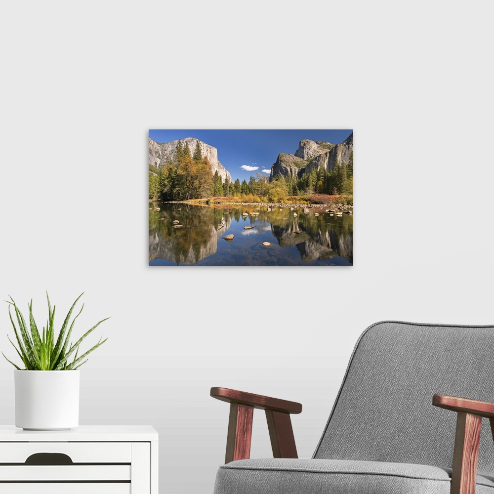 A modern room featuring El Capitan and Bridalveil Falls in Yosemite reflected in the clear water of the River Merced.