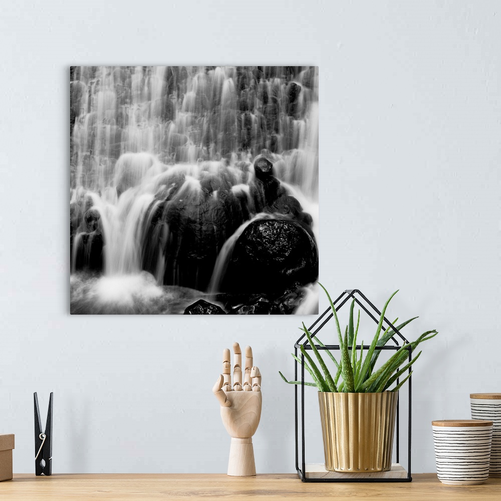 A bohemian room featuring waterfall, rocks, photographic, black and white