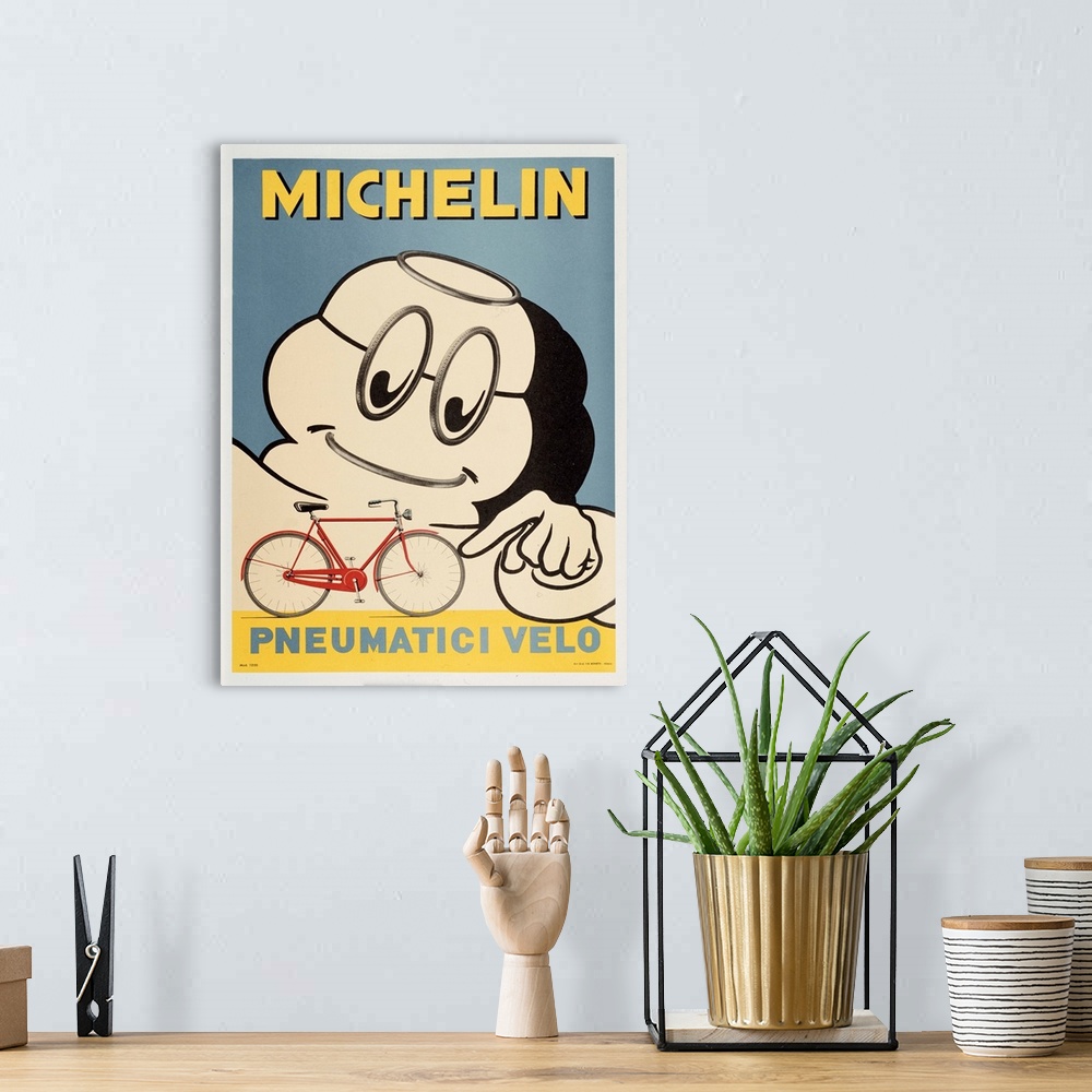 A bohemian room featuring Michelin man pointing to the tires on a bicycle.