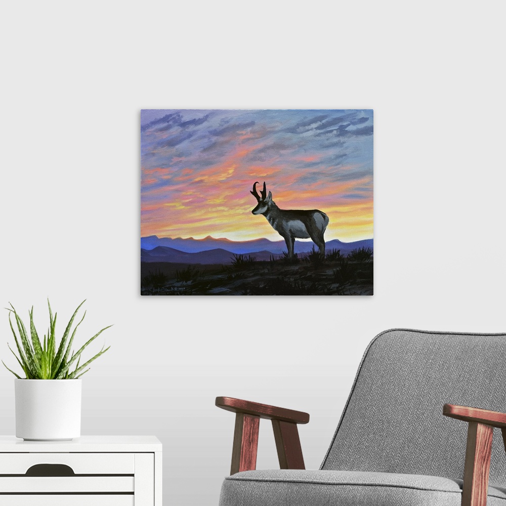 A modern room featuring Contemporary painting of a deer standing outside with a beautiful sunset in the sky over the moun...