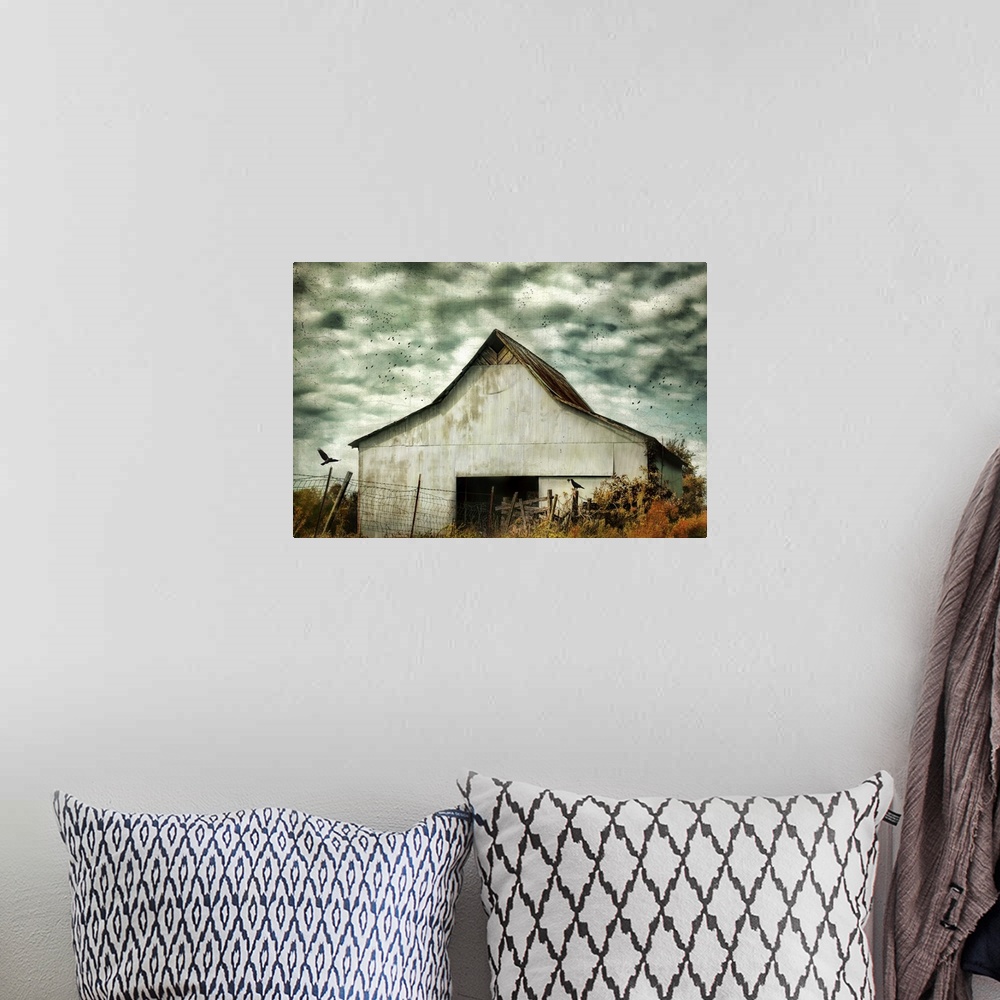 A bohemian room featuring Fine art photo of a barn under stormy skies with crows flying by.