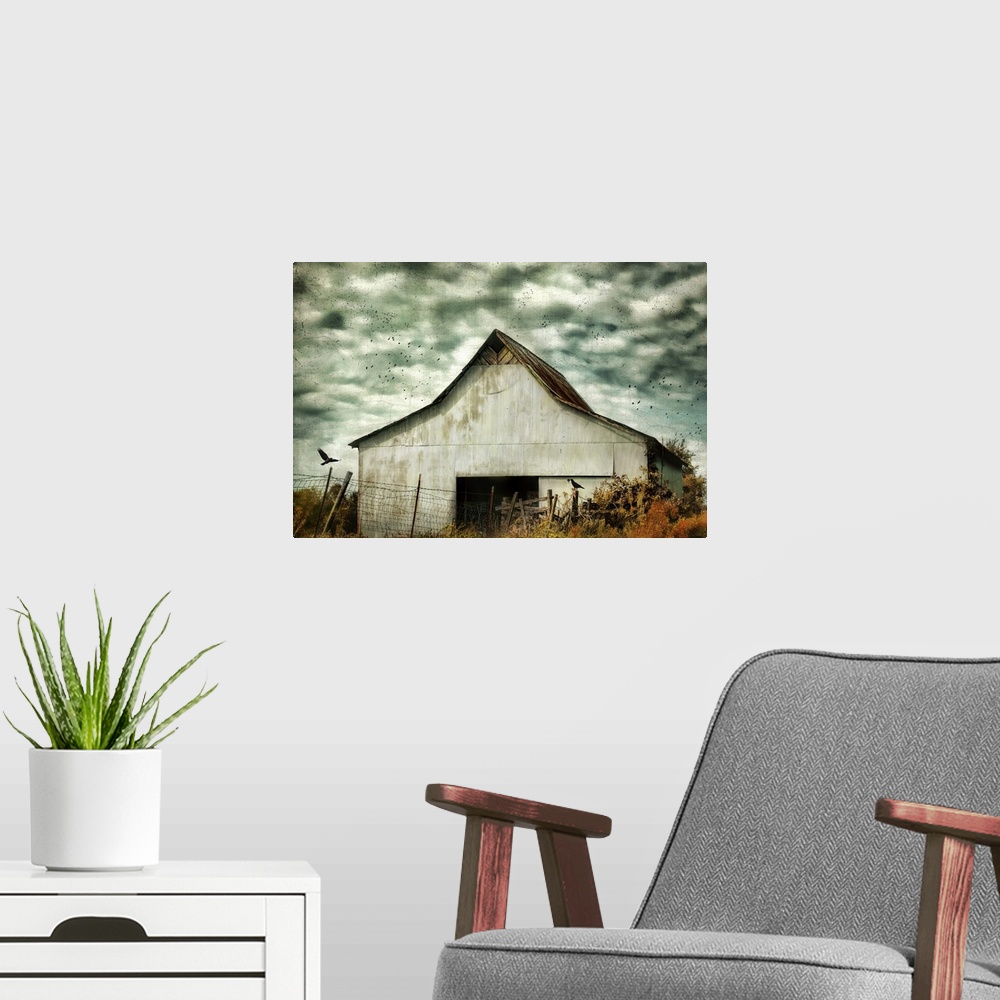 A modern room featuring Fine art photo of a barn under stormy skies with crows flying by.