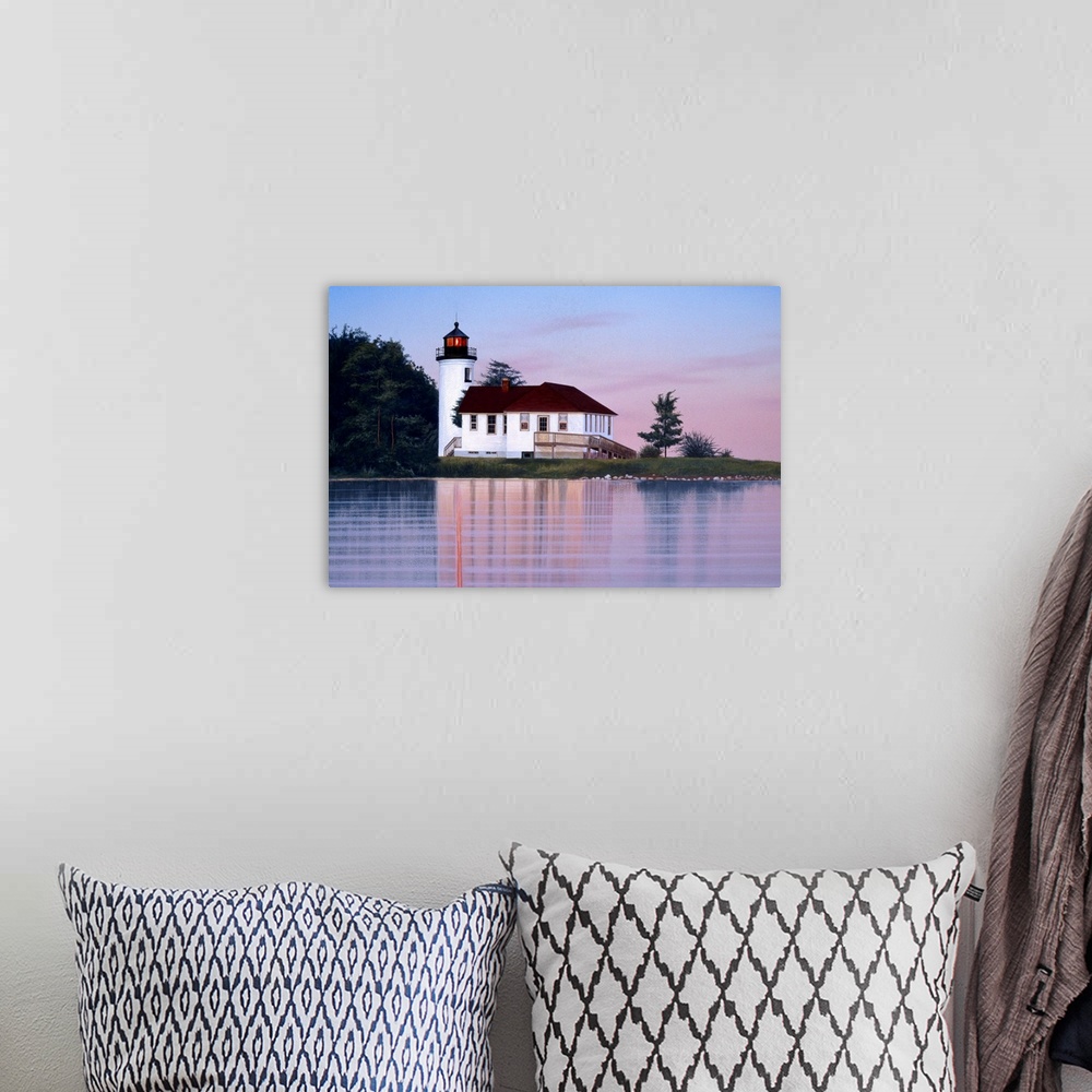 A bohemian room featuring A white lighthouse and house at sunset (or sunrise).