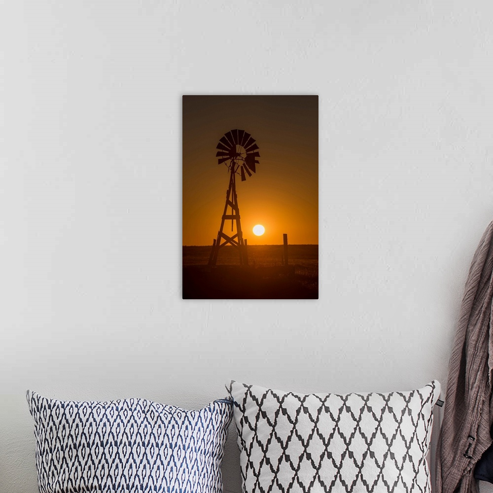 A bohemian room featuring Silhouette photograph of a windmill at sunset with the round sun sitting right above the horizon ...