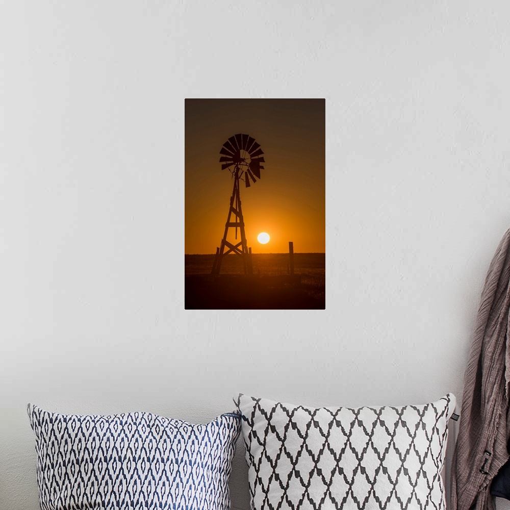 A bohemian room featuring Silhouette photograph of a windmill at sunset with the round sun sitting right above the horizon ...