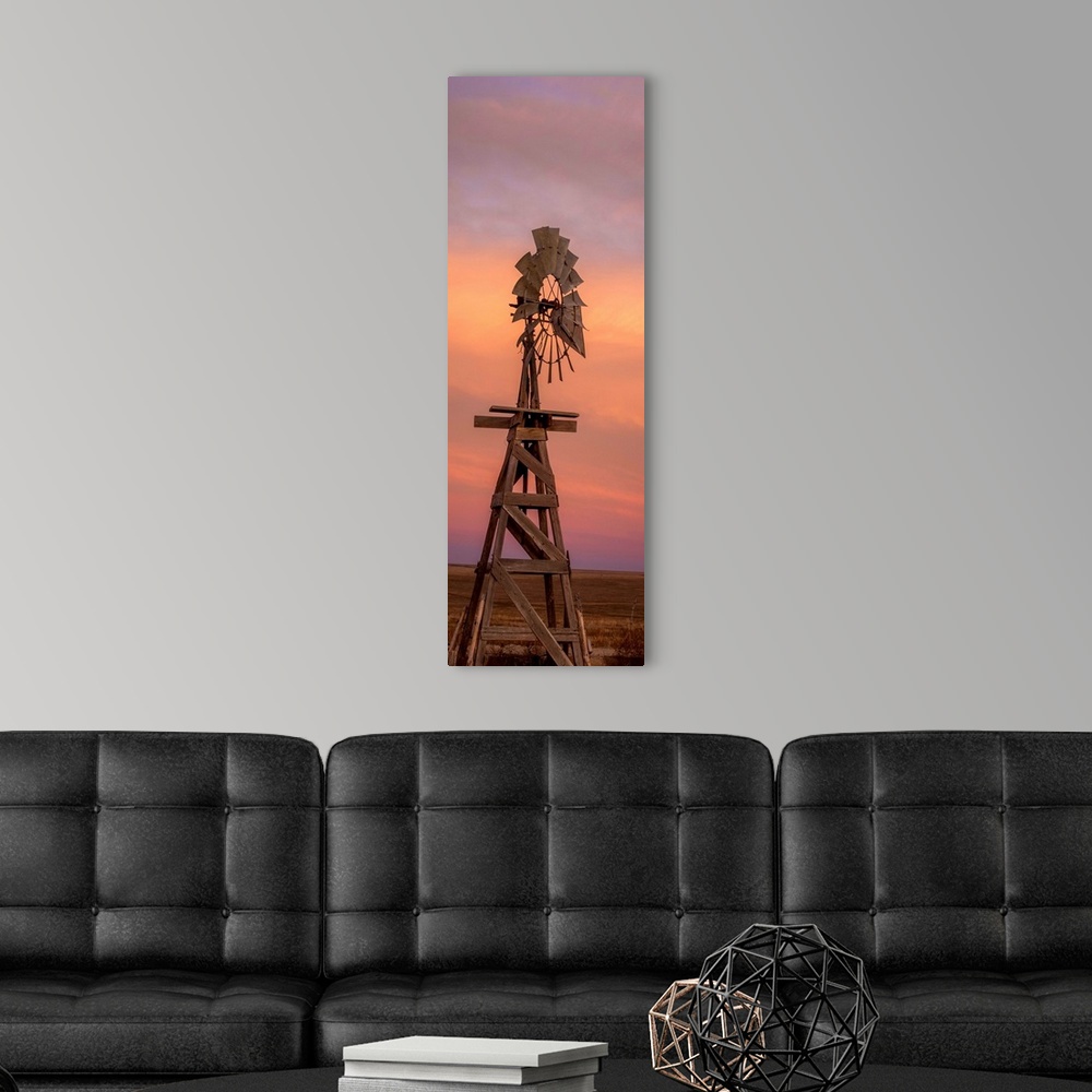 A modern room featuring Tall photograph of a wooden windmill at sunset.
