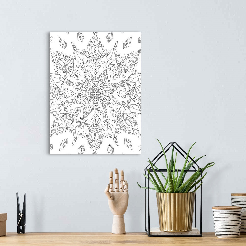 A bohemian room featuring Black and white line art of an intricately designed snowflake.