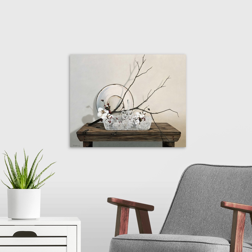 A modern room featuring Wire basket on table with branch of cotton.