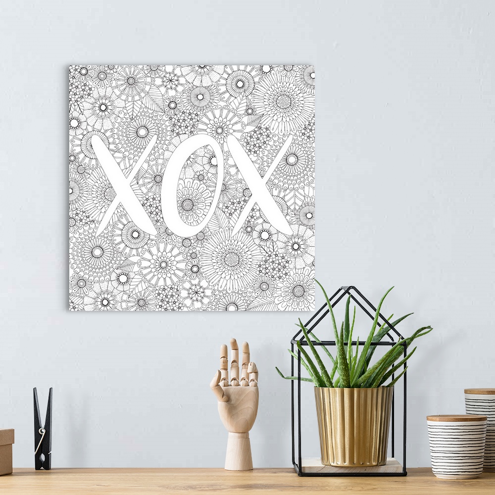 A bohemian room featuring Black and white line art with the letters "XOX" written on top of a floral background.