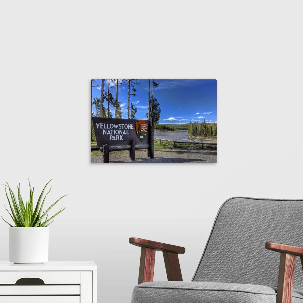 A modern room featuring A photograph of the Yellowstone National  Park sign in Wyoming.