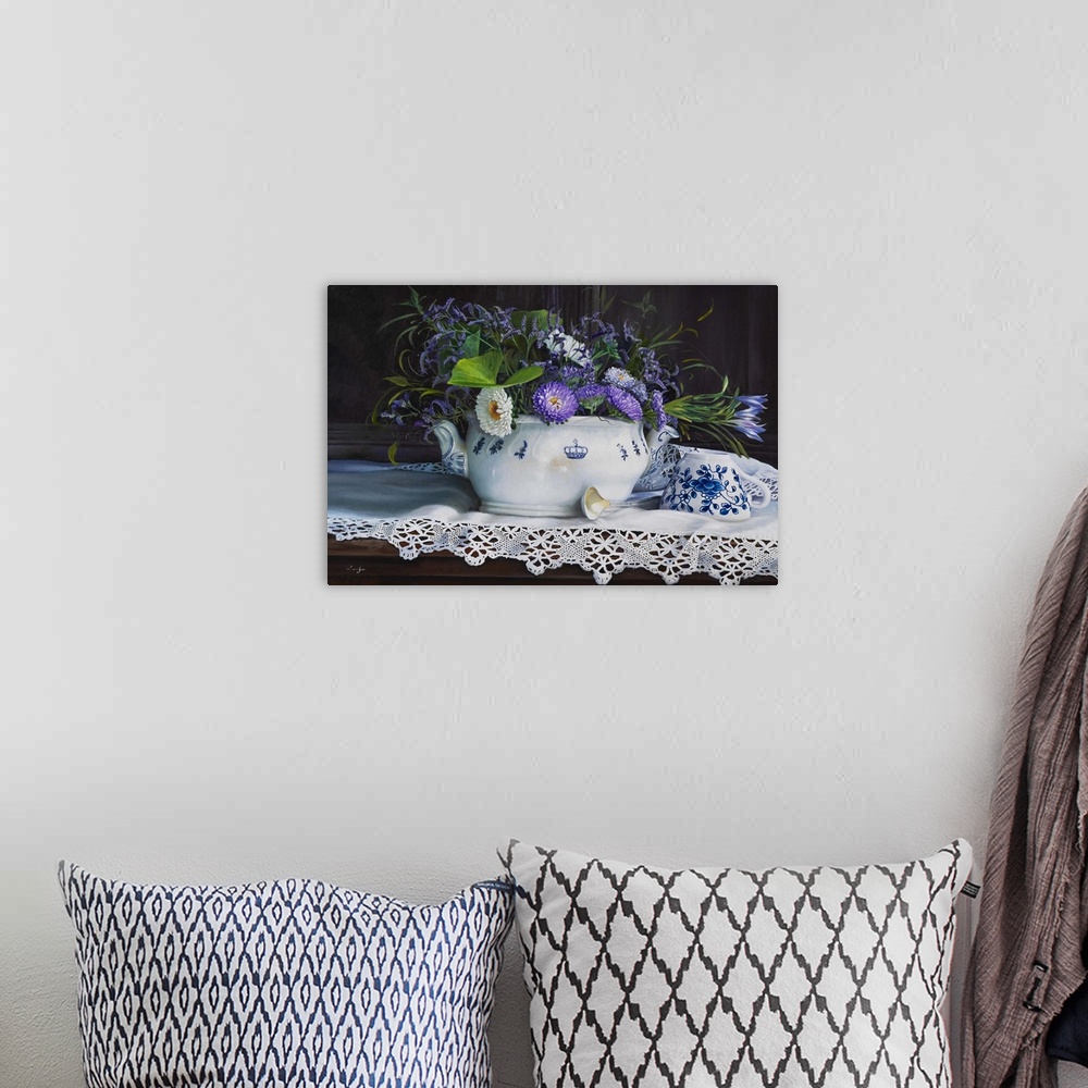 A bohemian room featuring Contemporary still life painting of a short white vase holding purple flowers on a lace cloth.