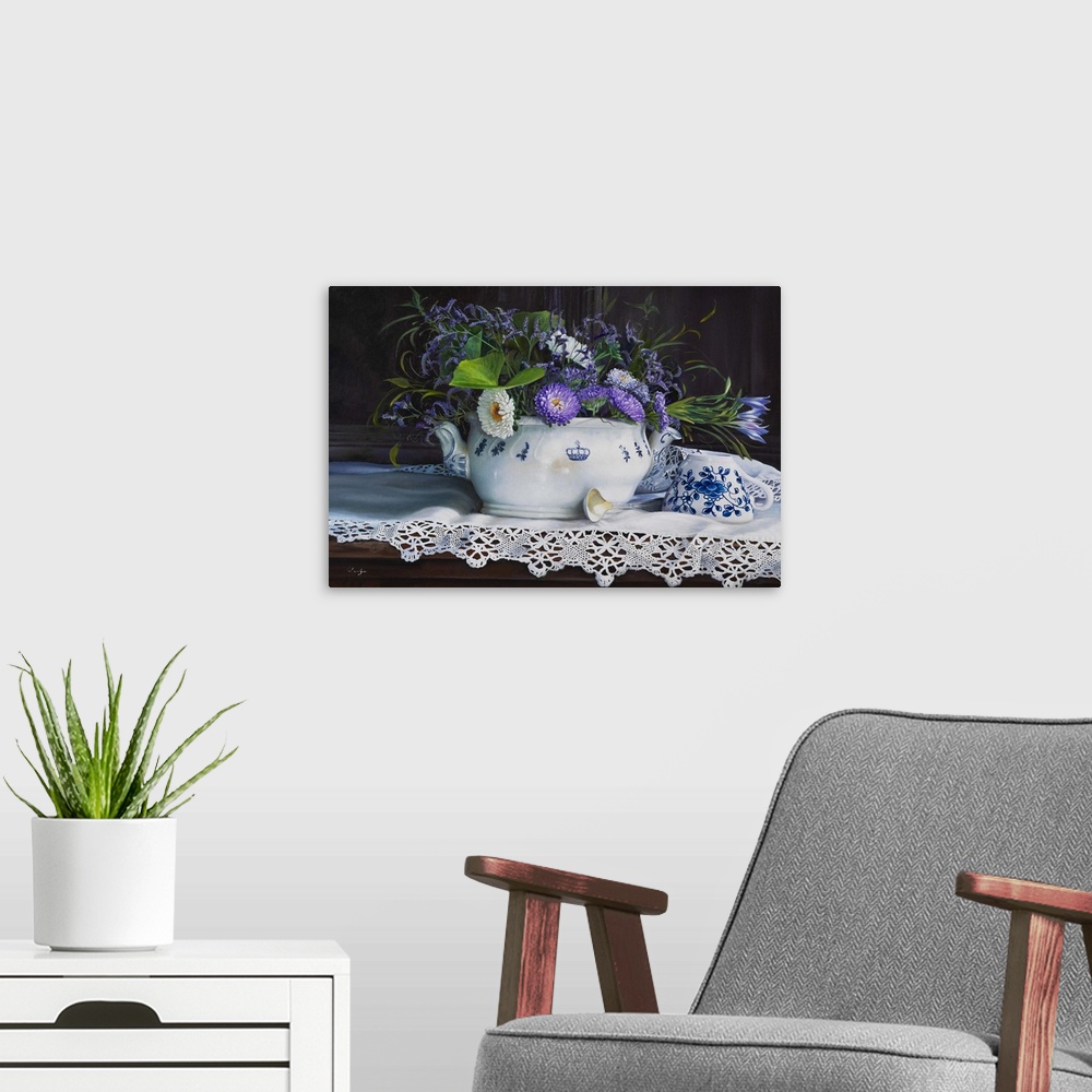 A modern room featuring Contemporary still life painting of a short white vase holding purple flowers on a lace cloth.