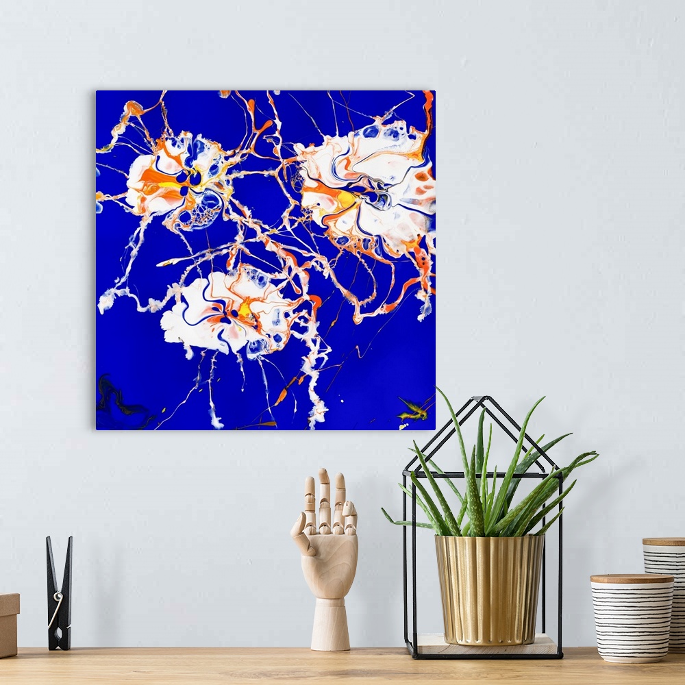 A bohemian room featuring Floral painting in pouring technique using white, orange and yellow paint on a contrasting backgr...
